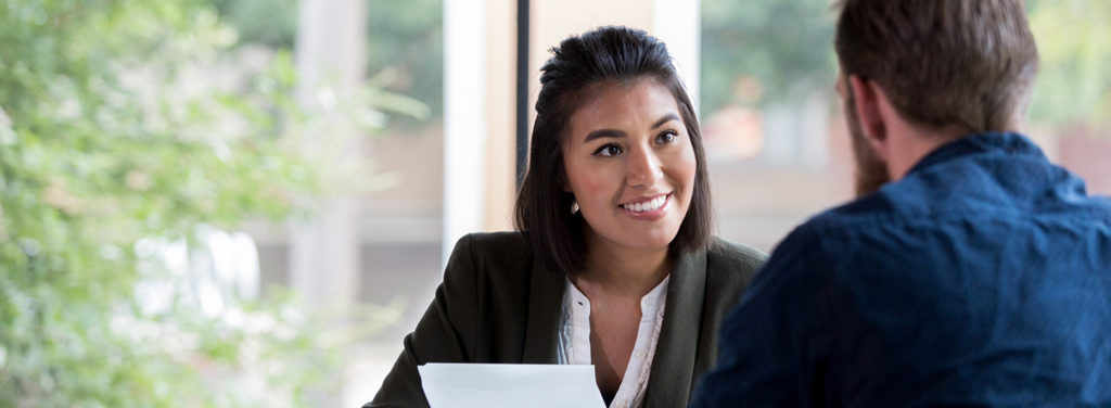 Woman facing man in business professional setting