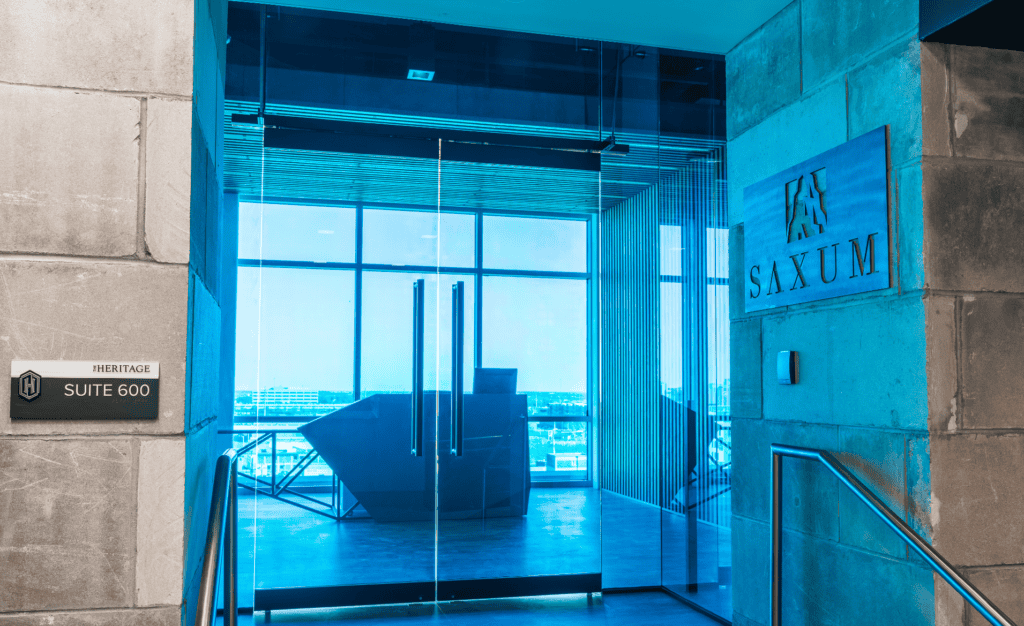 Modern office building entrance at Saxum with contemporary design and glass doors.
